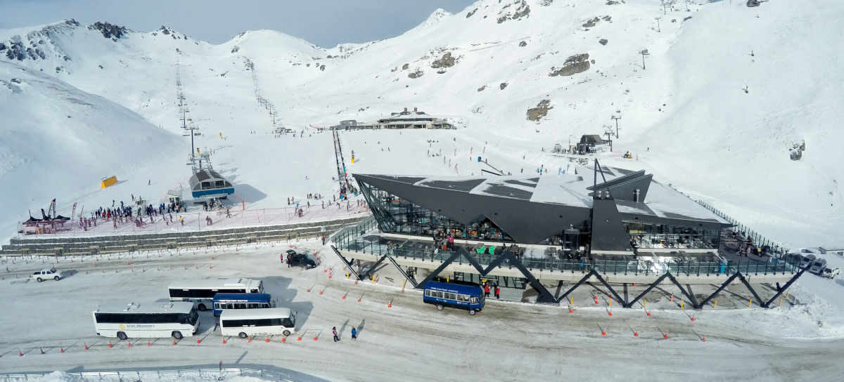 The Remarkables base building and ski buses in car park Queenstown