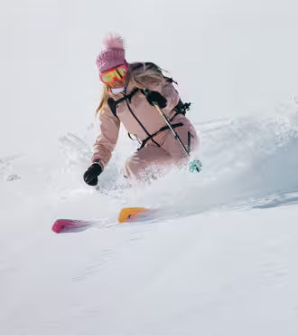Skis for Hire in Queenstown NZ - Female skiing in powder