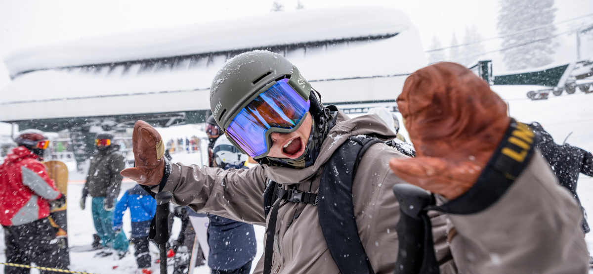 Excited skier in helmet and goggles
