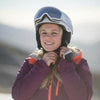 Person wearing a helmet and ski jacket with a blurred background
