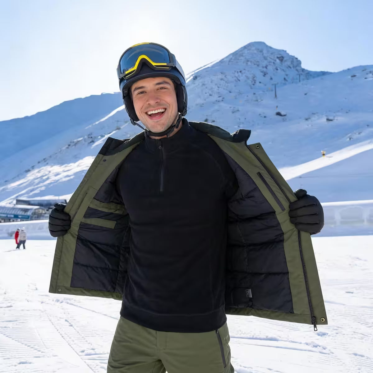 Person in ski gear with a helmet and goggles, standing on a snowy mountain.